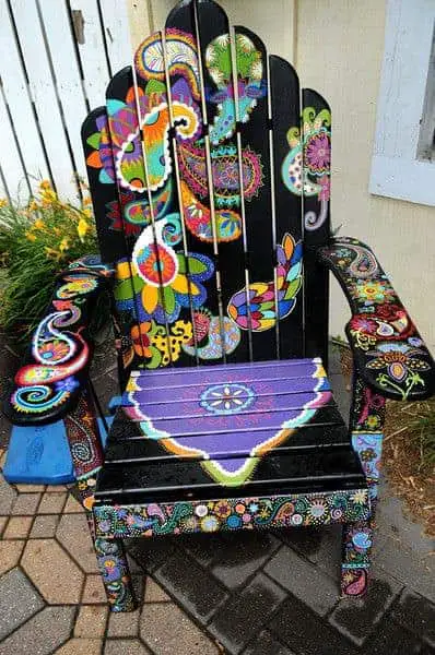 An Adirondack Chair titled "Playful Paisley" by Ashley Hadfield sits in front of Eichten's Market and Bistro in Center City is part of the Highway 8 Chairs project in Chisago County that has 37 Adirondack-style chairs, each painted by an area artist, along the stretch of highway between Chisago City and Taylors Falls Friday July 26, 2013.The project was launched by a local nonprofit group to draw visitors to businesses who have suffered during recent road work. (Pioneer Press: Jean Pieri)