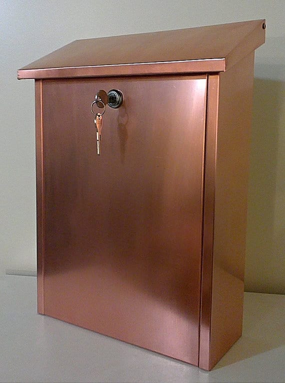 Strong and weather resistant, this Wall-Mounted Mailbox with a lock and made of copper is a brilliant choice!