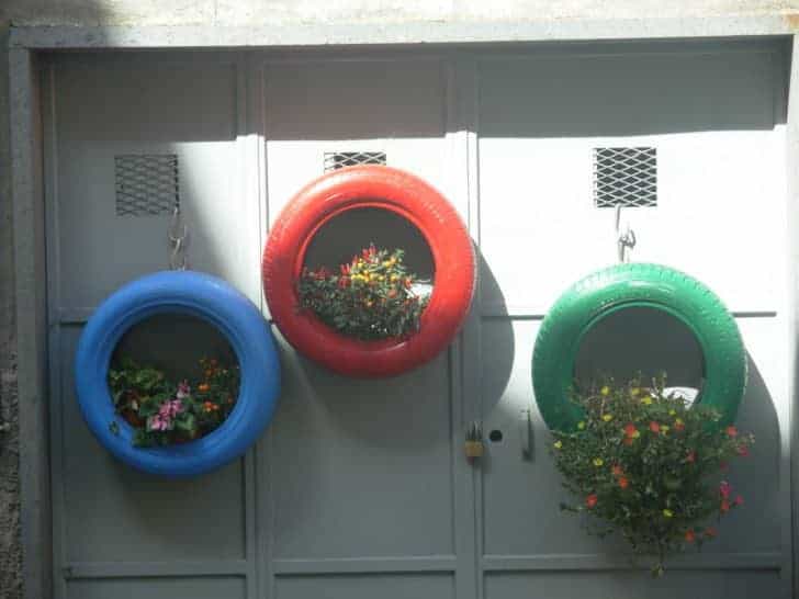 Tire Hanging Garden is made by upcycling an old tire and planting whatever you like, such as succulents, annuals, etc. inside and hanging it on a wall.